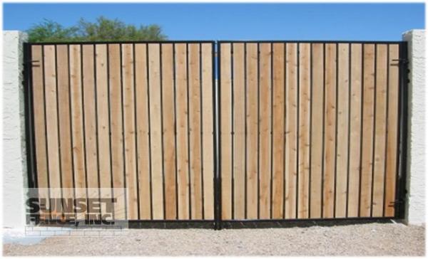 A wooden fence with metal posts and bars.