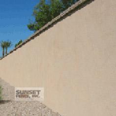 A concrete wall with the words sunset fence, inc. On it