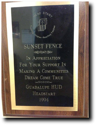 A plaque is displayed in front of the sunset fence.