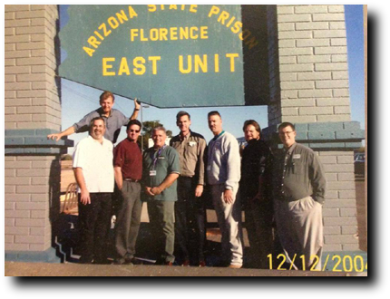 A group of men standing in front of a building.