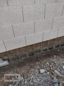 A concrete block wall with some bricks on it